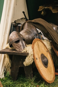 brown wooden round table with brown leather boots