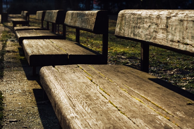 Set of durable concrete garden benches in an outdoor setting.