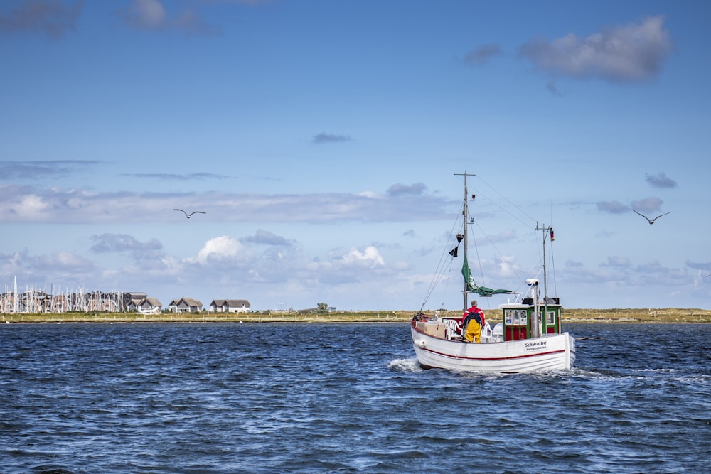 white and blue boat on sea during daytime