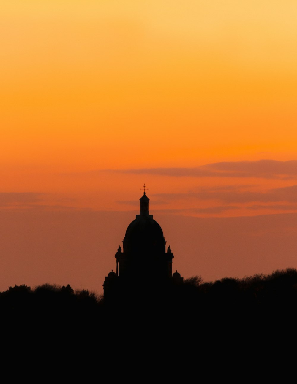 silhouette of statue during sunset