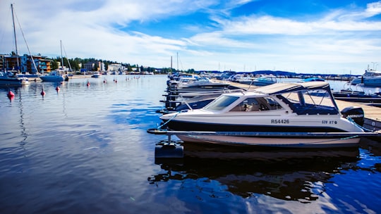 white and black boat on body of water during daytime in Kuopio Finland