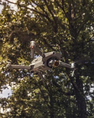 A sleek drone hovering over a scenic park, capturing aerial views.