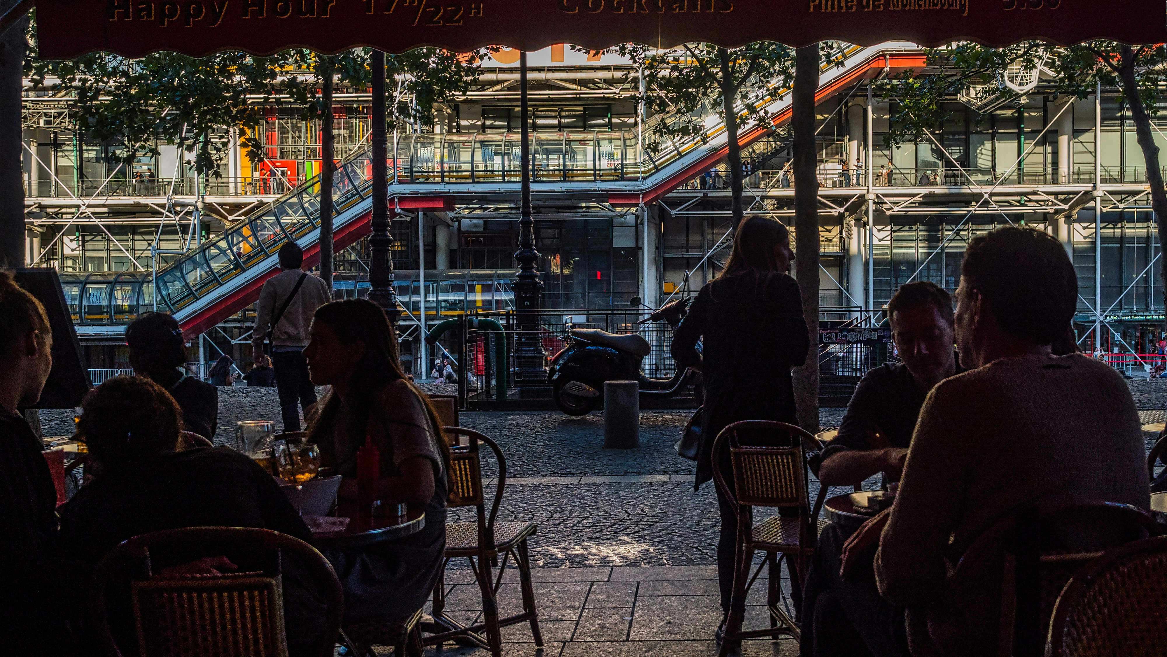 people sitting on chair near store during night time, 