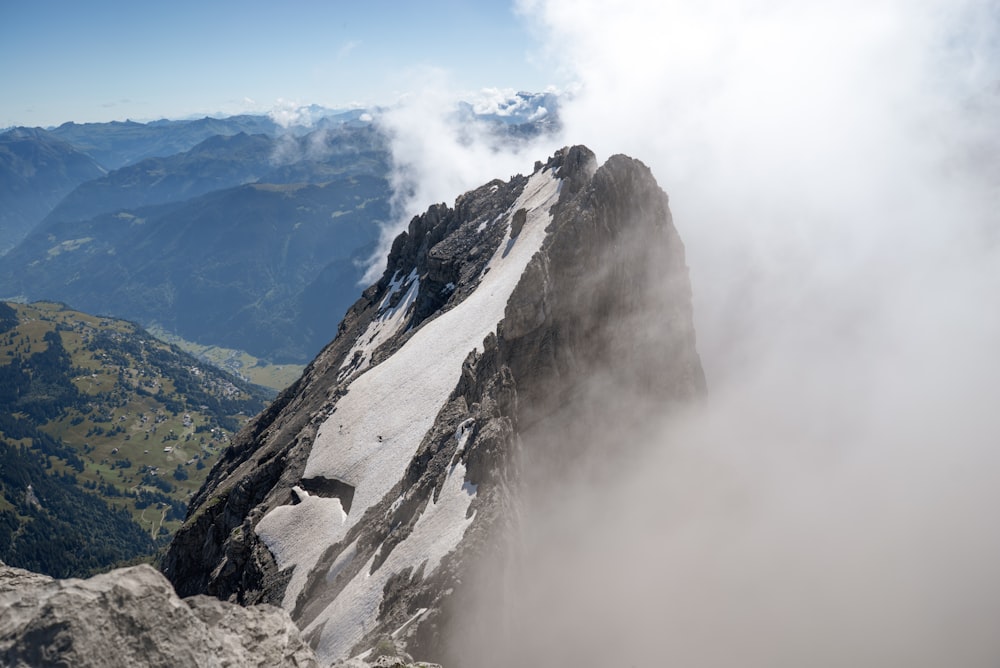 gray rocky mountain under white clouds during daytime