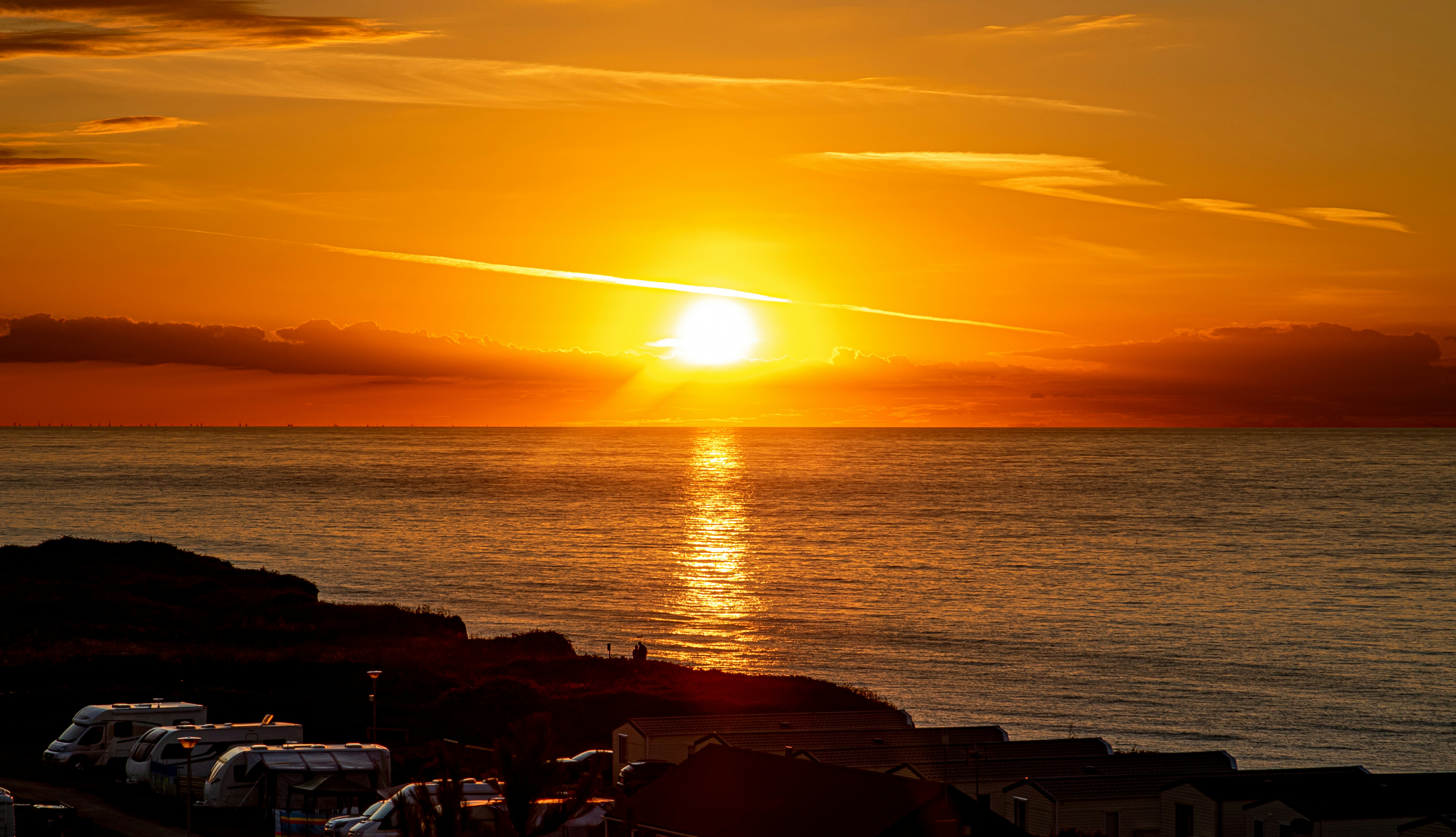 silhouette of people on beach during sunset