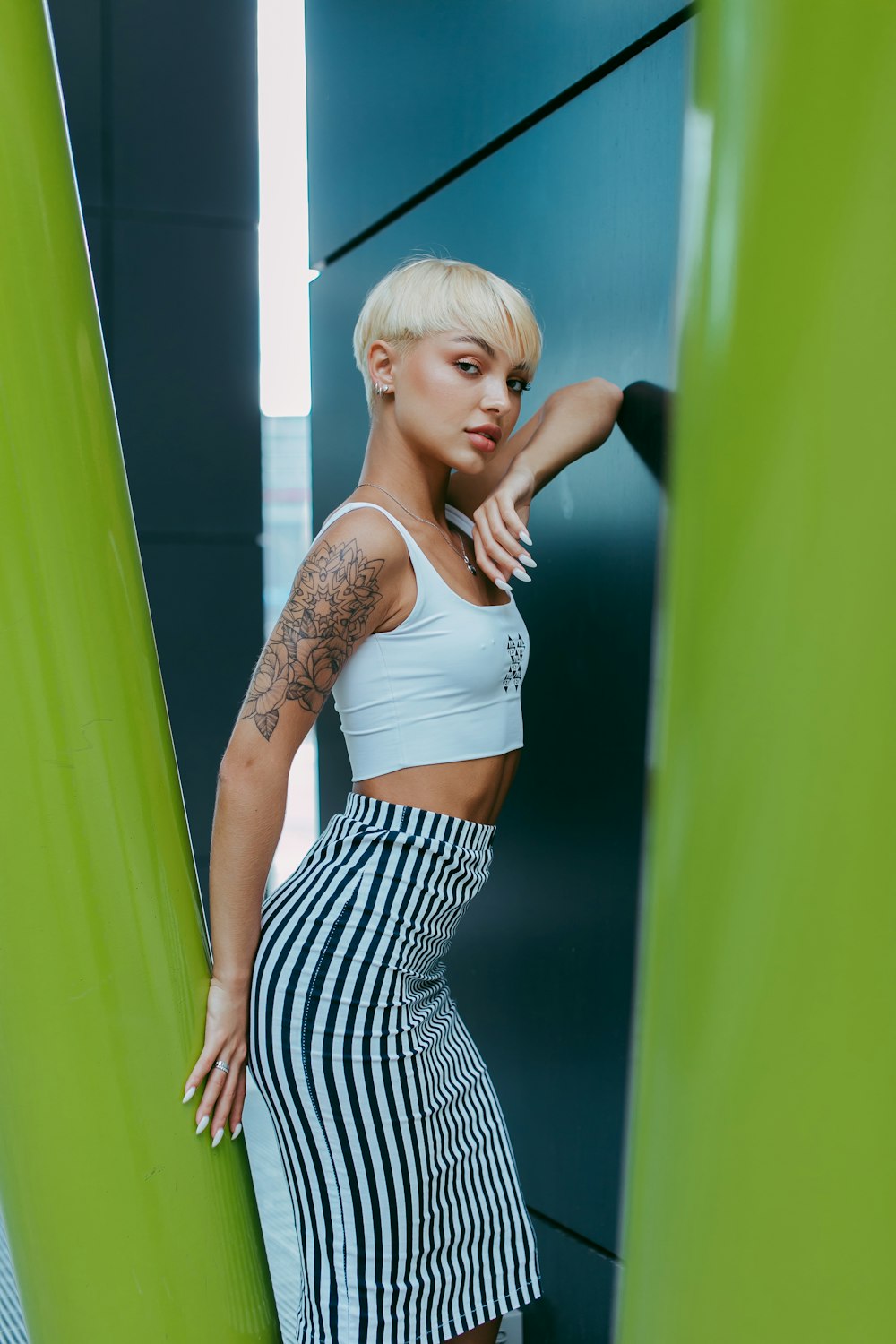 woman in white tank top and black and white striped skirt