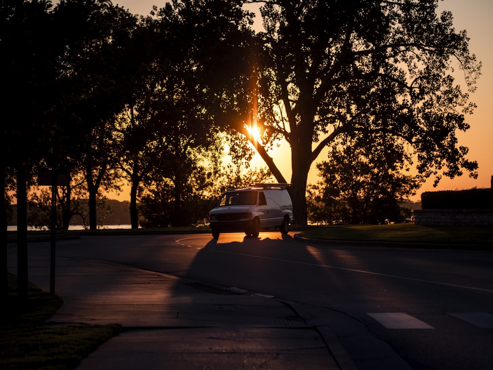 white car on road during sunset