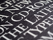 Close-up of white text illuminated against a deep black backdrop.