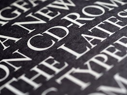 Close-up of white text illuminated against a deep black backdrop.