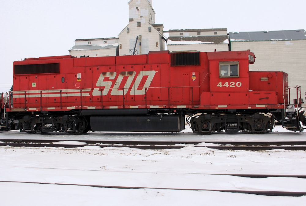 red and white train on rail tracks