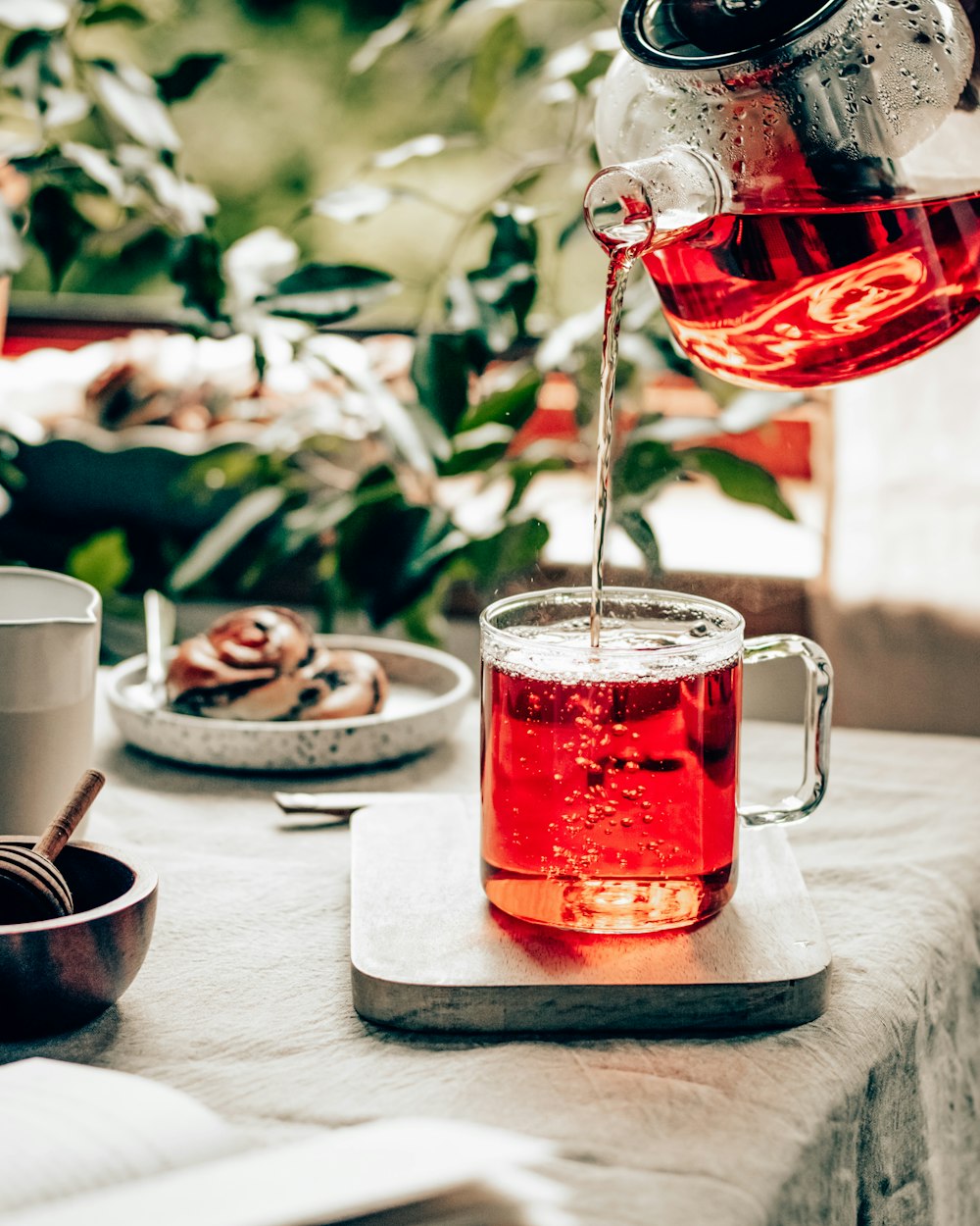 clear glass mug with red liquid on table