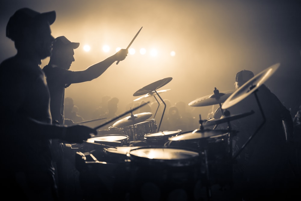 man playing drum with drum sticks