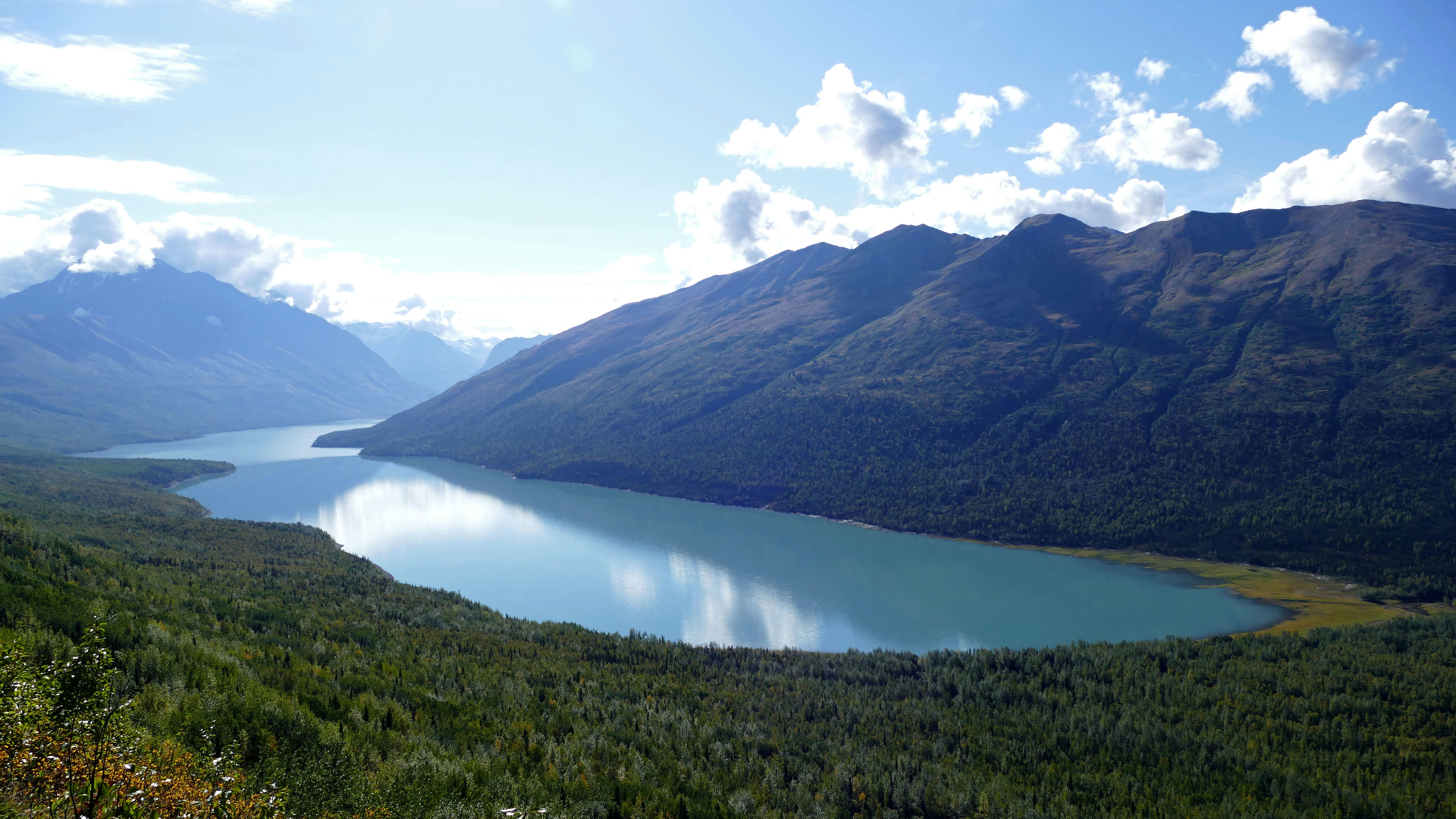 lake in the middle of mountains during daytime, Blue lake in Alaska