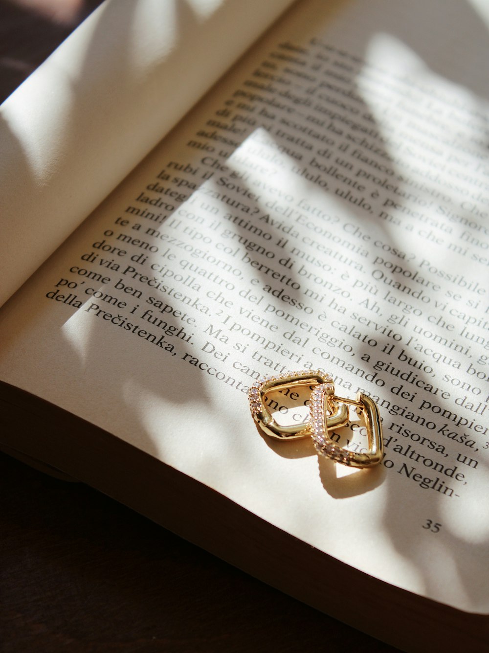gold ring on white book page
