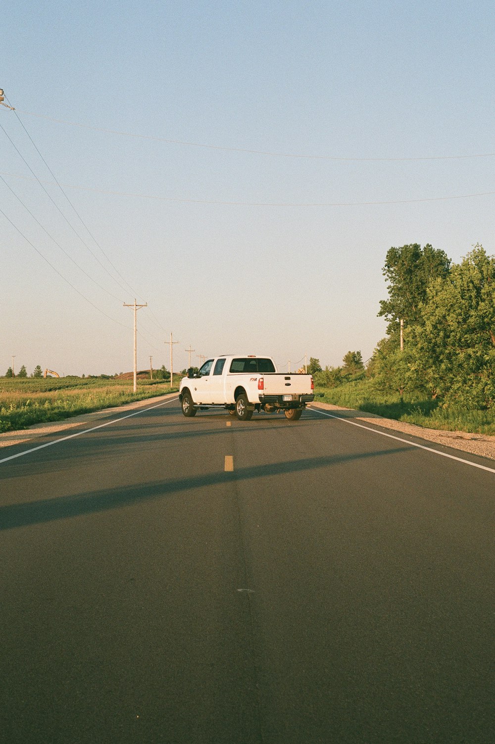 white crew cab pickup truck on road during daytime