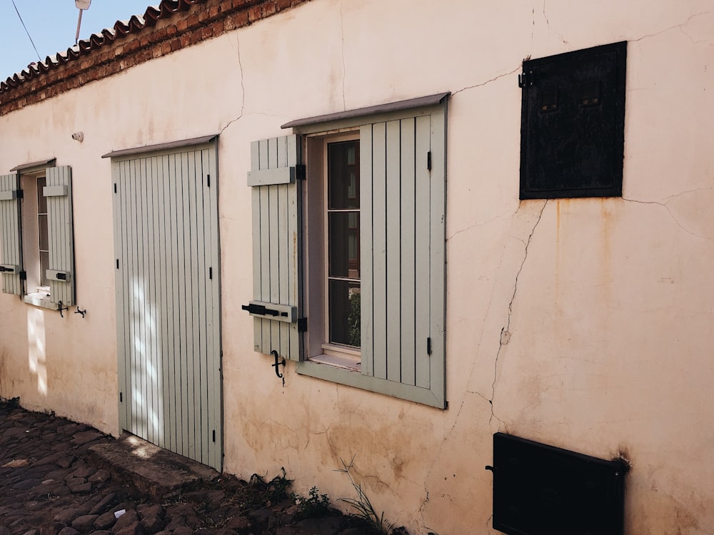 white wooden window frame on beige concrete wall