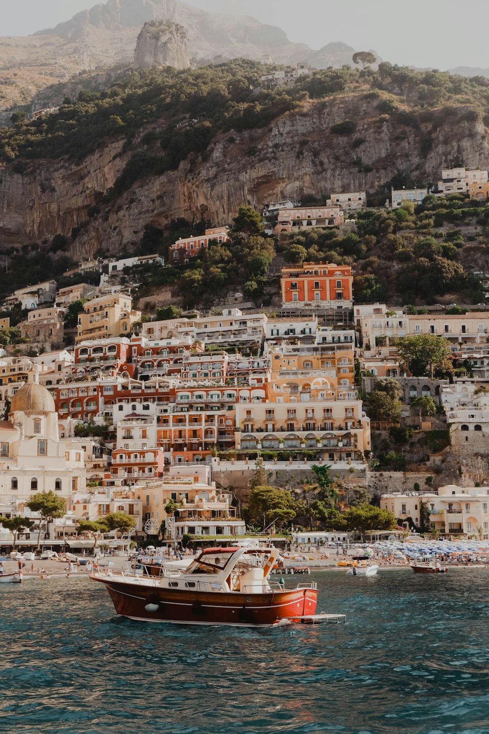 white and brown concrete buildings near body of water during daytime