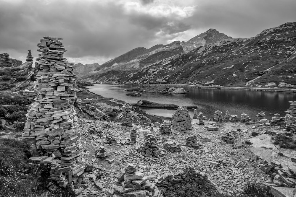 grayscale photo of lake near mountain