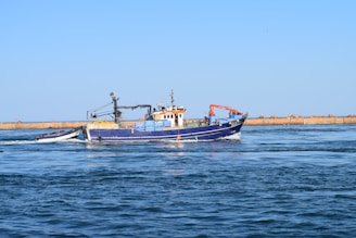 black and orange boat on sea during daytime