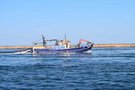 black and orange boat on sea during daytime