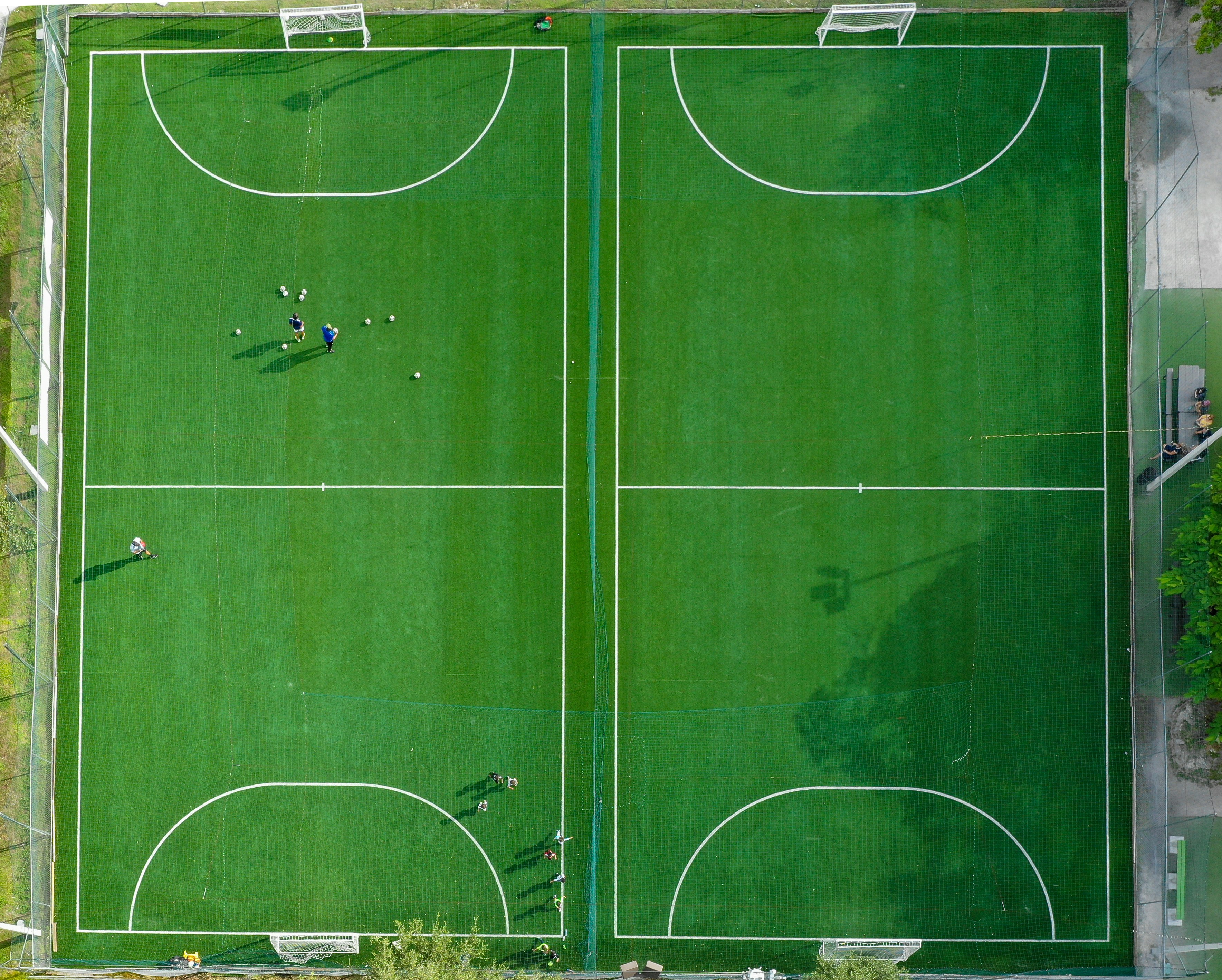 Aerial view of 2 soccer (futbol) pitches being used for practice drills