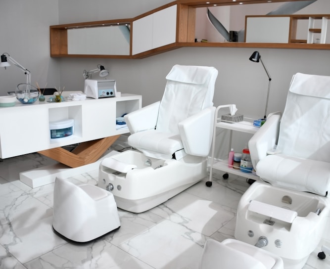 white rolling chairs near brown wooden desk