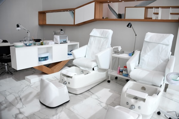 A comfortable pedicure chair with soft cushions and a modern foot bath ready for use.