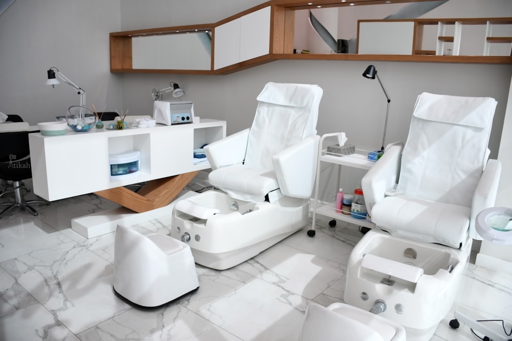 white rolling chairs near brown wooden desk