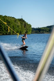 Child wakeboarding on Sparrow Lake, enjoying summer lake lifestyle.