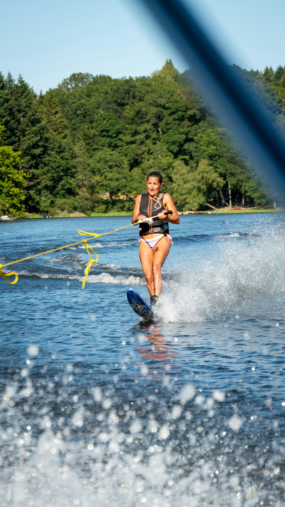 woman in black bikini on water during daytime