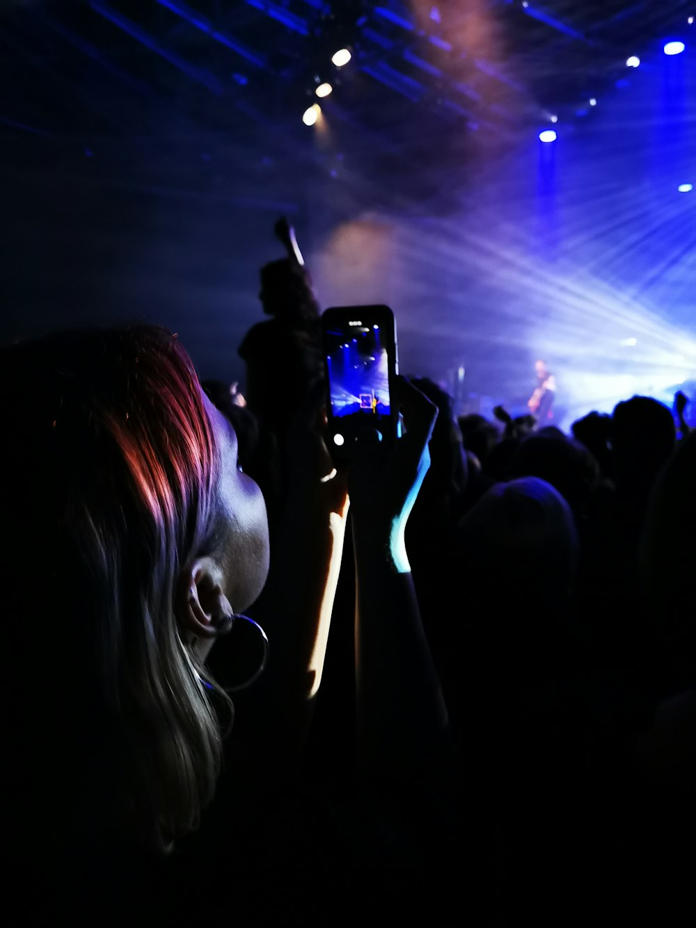 woman taking photo of people