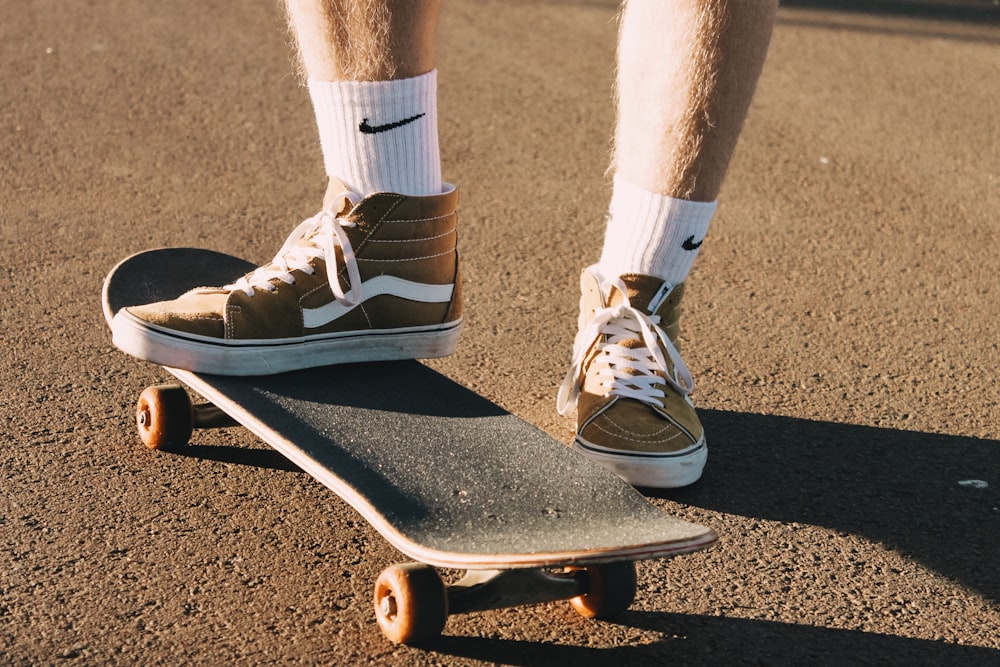 person in white socks and black and white nike sneakers