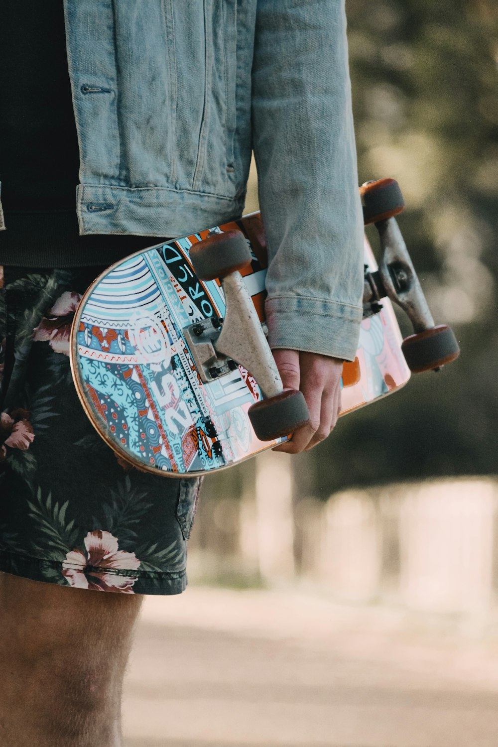 person in blue denim jeans and black and white floral shirt