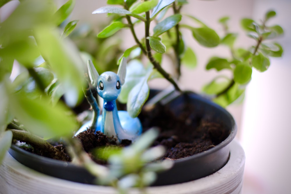 blue and white animal figurine on brown round pot