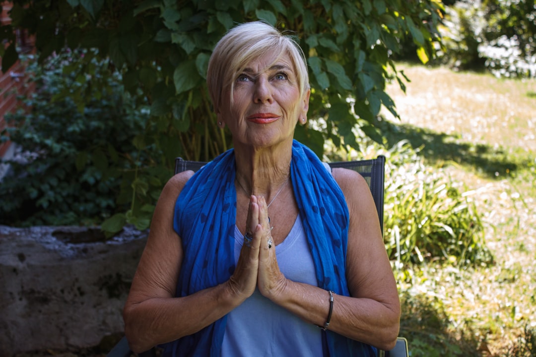 woman in blue sleeveless shirt sitting on chair