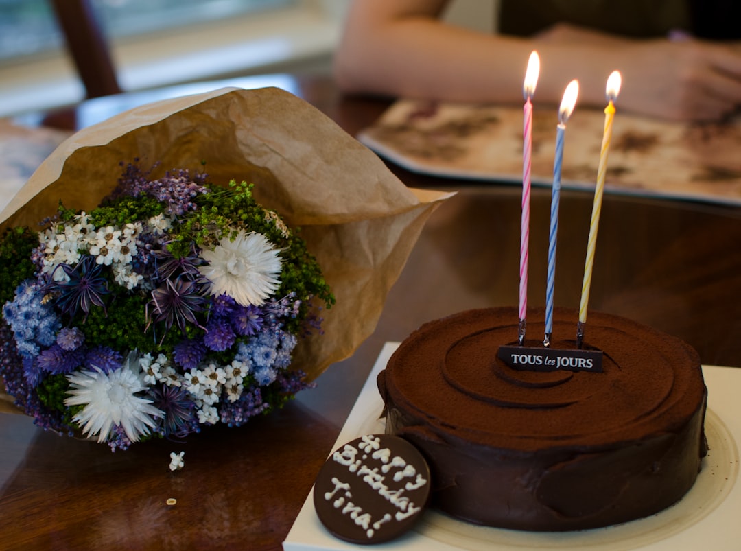 chocolate cake with candles on brown wooden table