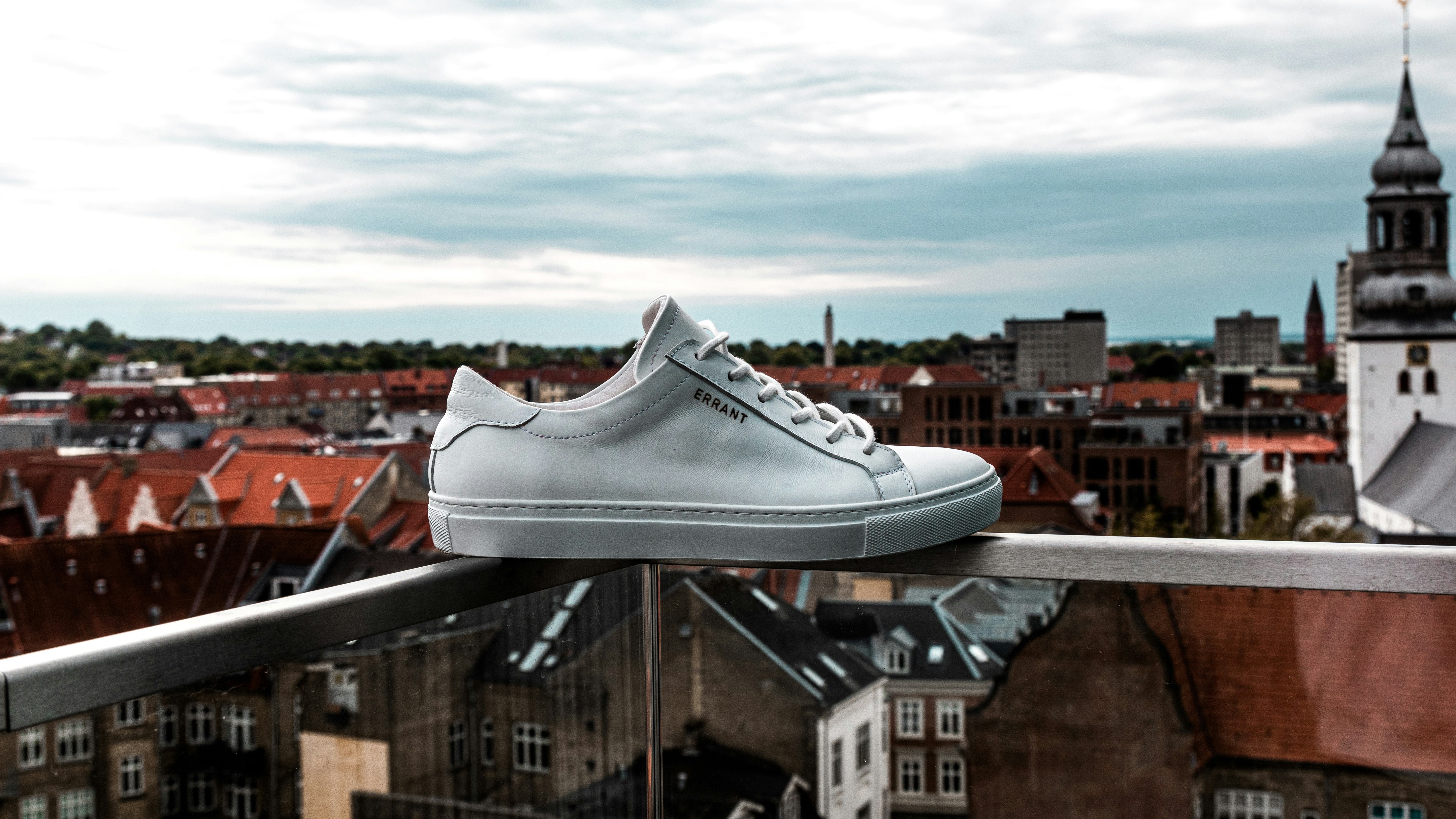 white nike low top sneakers on brown wooden table