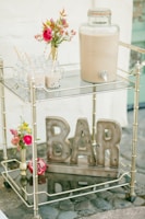 A pony serving drinks from a beautifully decorated cart.