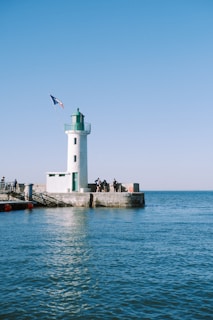 white lighthouse on dock during daytime
