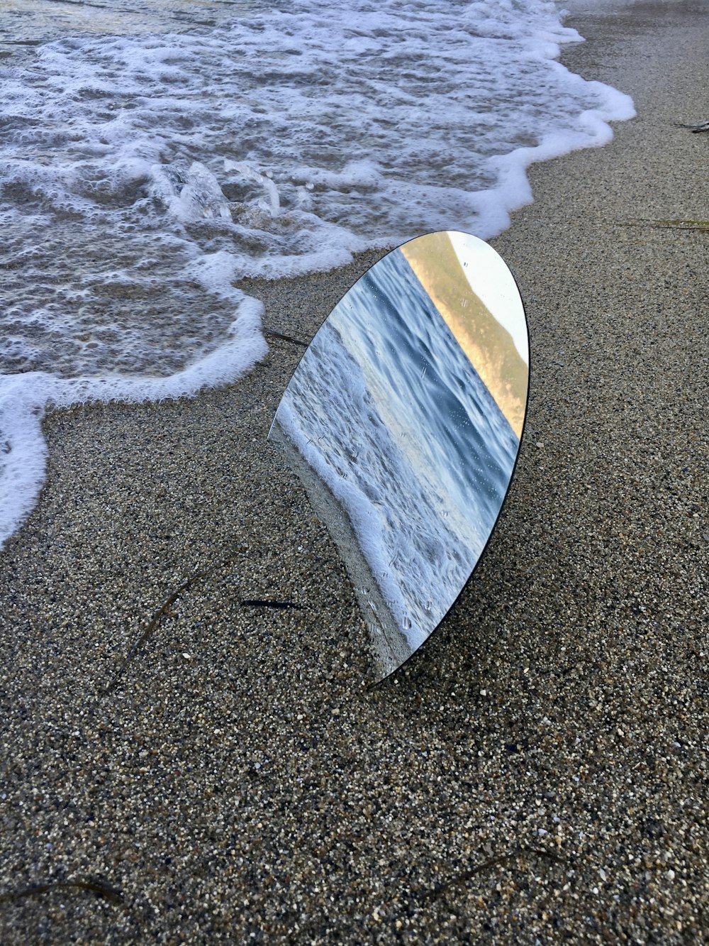 brown and white surfboard on beach shore during daytime