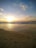 A scenic view of a sunset over a tranquil beach.