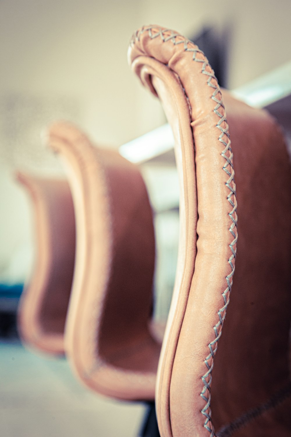 brown leather padded chair in room