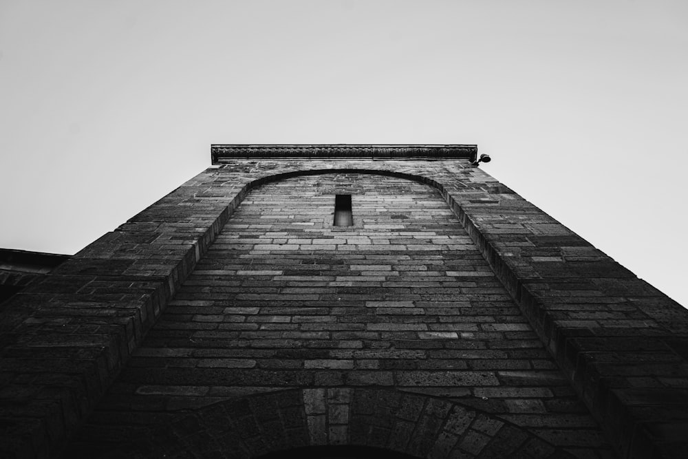 grayscale photo of brick wall