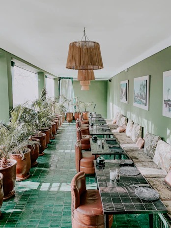 Brightly lit seating area with plants and modern artwork.