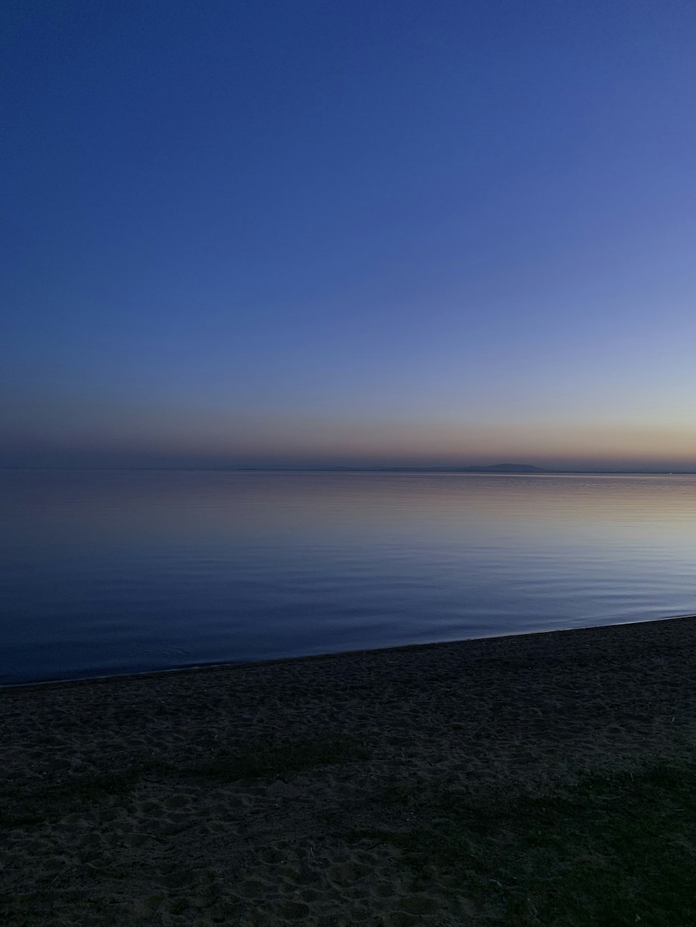 calm sea under blue sky during daytime