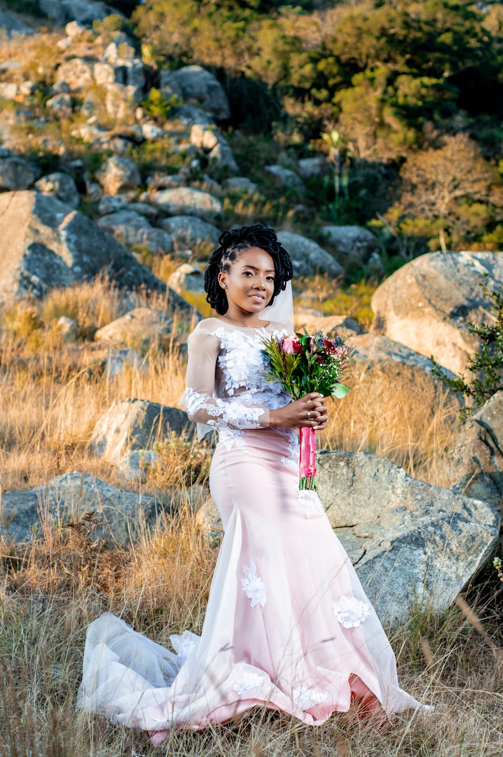 woman in white wedding dress holding bouquet of flowers