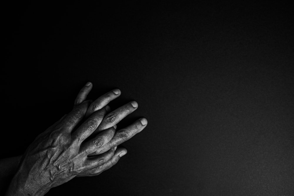 grayscale photo of persons hand