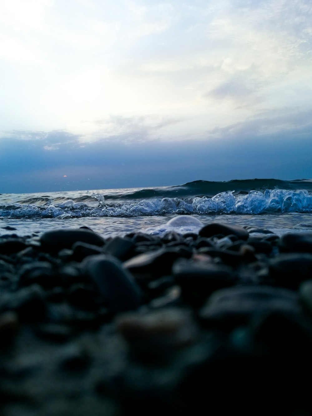 black stones on seashore during daytime