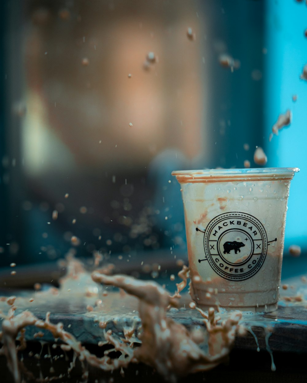 white and blue plastic cup