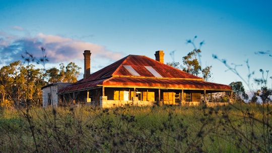 brown and white wooden house near green trees under blue sky during daytime in Annangrove NSW Australia